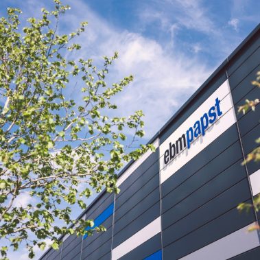 Decorative lettering displaying ebm-papst logo at a corporate building